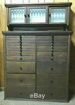 AWESOME 1920's OAK DENTAL CABINET WITH ETCHED CLASS AND 22 MULTI SIZE DRAWERS