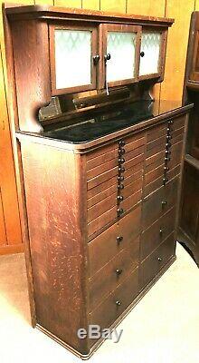 AWESOME 1920's OAK DENTAL CABINET WITH ETCHED CLASS AND 22 MULTI SIZE DRAWERS