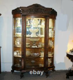 Antique Fancy Curved Glass Oak China Cabinet with carved Lions and claw feet