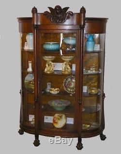 Antique Oak China Curio Cabinet with carved Cherub in the crest