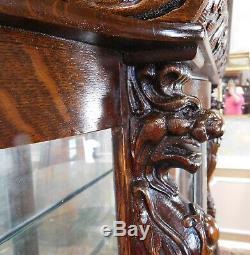 Antique Victorian Carved Figural Quartered Oak Curved Glass Curio Cabinet c1900