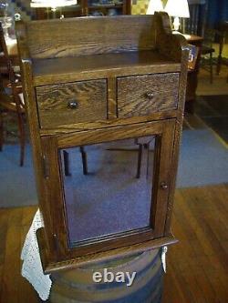 Antique oak Medicine cabinet Mission style with beveled edge mirror 1900's