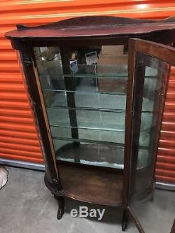 Round oak china cabinet- mirrored back with glass shelves from early 1900's