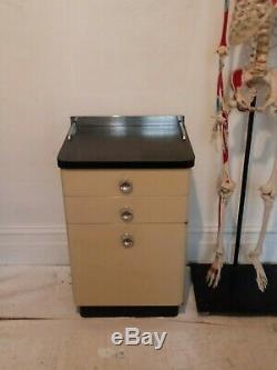 Vintage medical cabinet a. S. Aloe co. Metal 2 drawer mcm stand tan black chrome