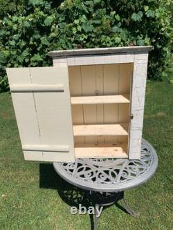 Wooden wall-hanging cabinet heavily crackled, chippy off-white paint antique