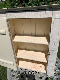 Wooden wall-hanging cabinet heavily crackled, chippy off-white paint antique
